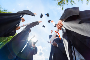 Graduation caps in the air