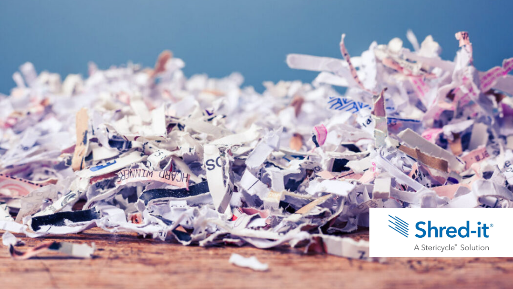 Shredded paper with Shred-it logo.